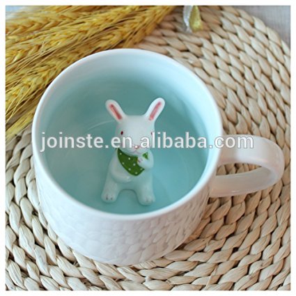 Blue ceramig mugs with cute figurine bunny inside